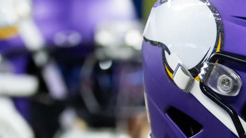 Vikings defensive back runs onto the field during a playoff game.