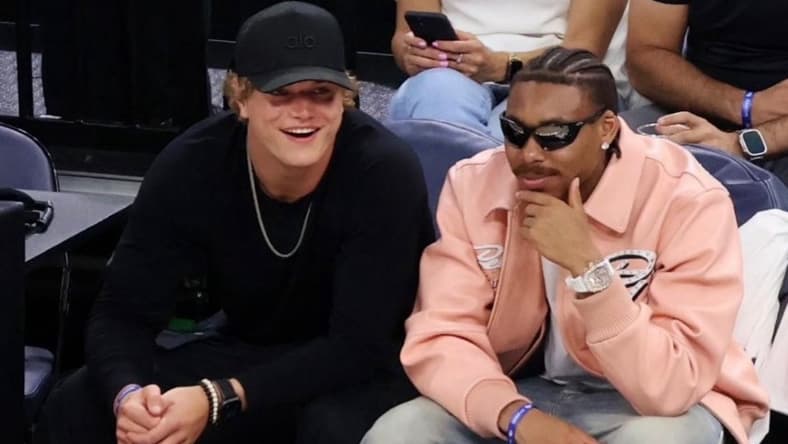 J.J. McCarthy and Justin Jefferson at a Timberwolves playoff game cheering courtside.
