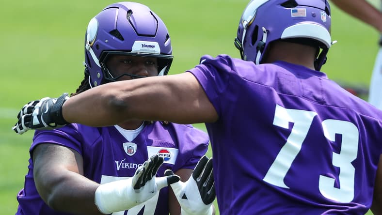 Donovan Jackson and Walter Rouse participate in drills during Vikings minicamp in Minneapolis.