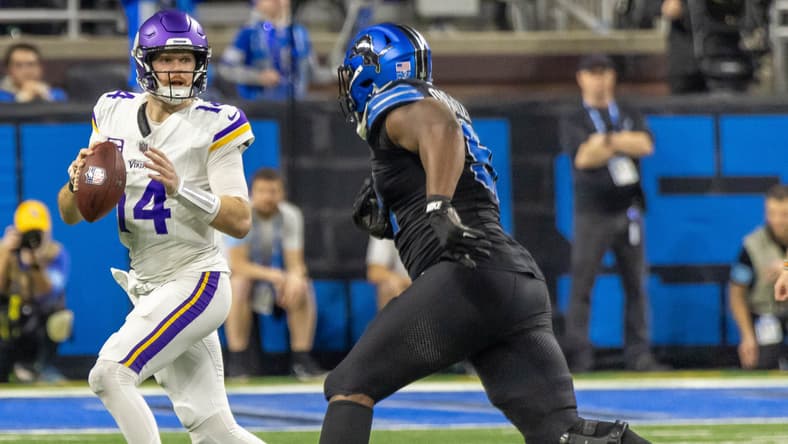 Vikings QB Sam Darnold pursued by Levi Onwuzurike in 2024.