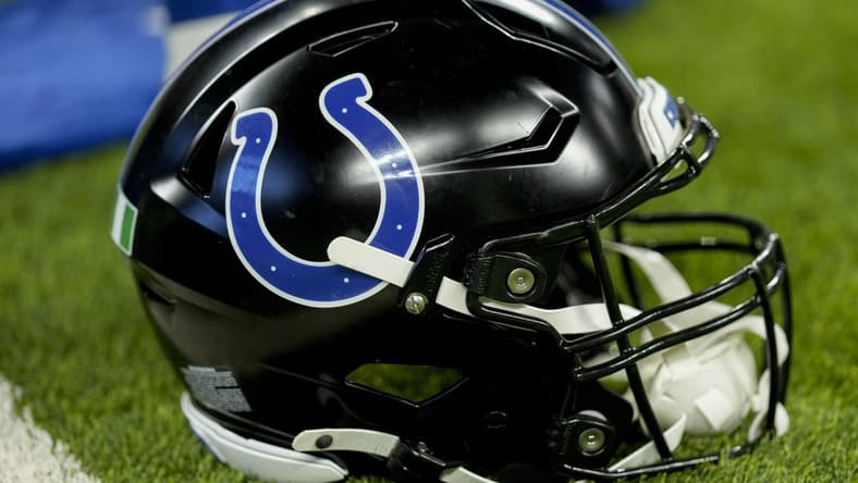 A black Indianapolis Colts helmet sits on the turf before the Colts-Lions game at Lucas Oil Stadium.