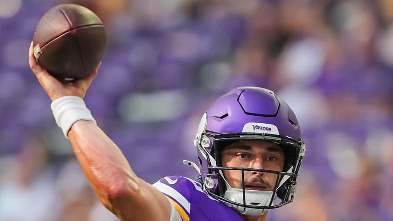Max Brosmer throws a touchdown pass for the Vikings against the Texans.