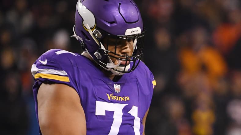 Kirk Cousins and Christian Darrisaw celebrate a Vikings touchdown.