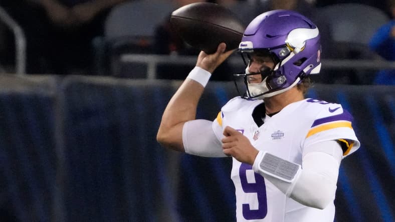 Minnesota Vikings quarterback J.J. McCarthy drops back to pass against the Chicago Bears at Soldier Field. Vikings training camp