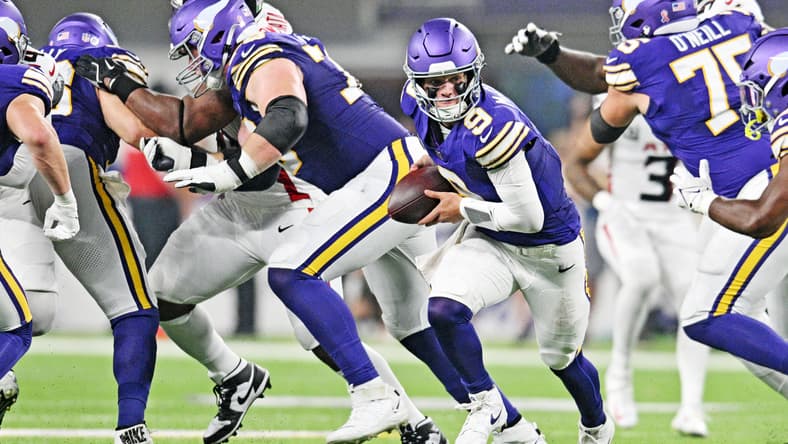 J.J. McCarthy runs the ball for the Vikings against the Falcons at U.S. Bank Stadium.