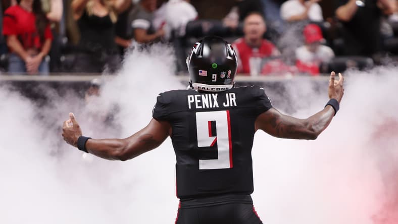 Michael Penix Jr. runs onto the field before a Falcons game against the Buccaneers at Mercedes-Benz Stadium. J.J. McCarthy