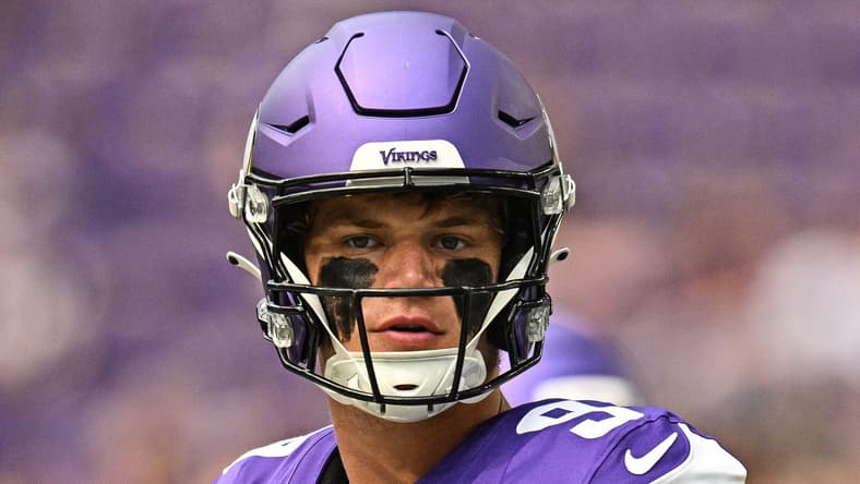 J.J. McCarthy warms up on the field at U.S. Bank Stadium before a preseason game against the Houston Texans.