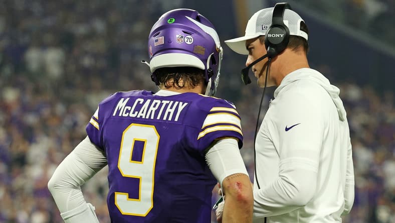J.J. McCarthy talks with Kevin O’Connell on the Vikings sideline during the game against the Falcons.