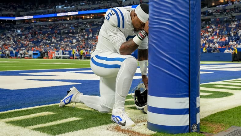 Colts quarterback Anthony Richardson prays on the field before a game against the Broncos.