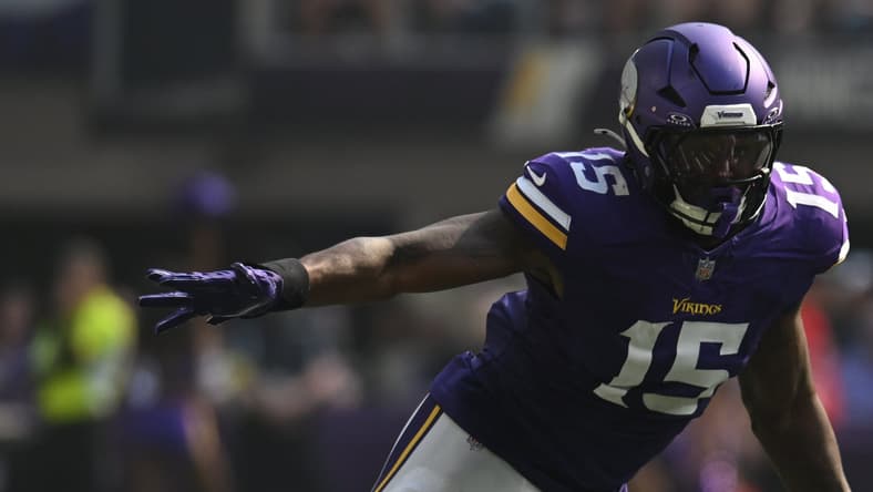 Dallas Turner pressures Jake Browning during a Vikings-Bengals game.