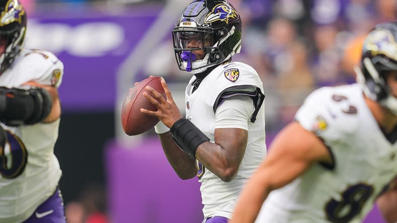 Lamar Jackson drops back to pass against the Vikings at U.S. Bank Stadium.