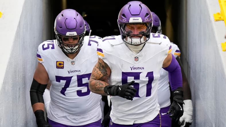 Blake Cashman and Brian O'Neill take the field before a Vikings game against the Packers at Lambeau Field.
