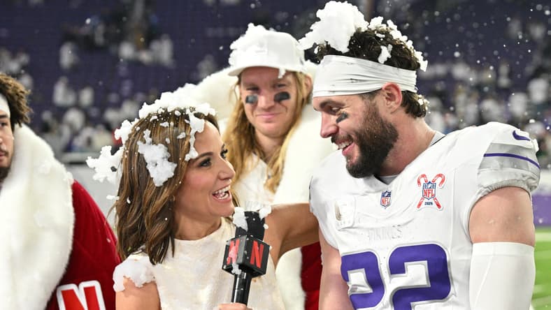 Vikings defenders speak with Seth Rollins and Dianna Russini after a game against the Lions at U.S. Bank Stadium.