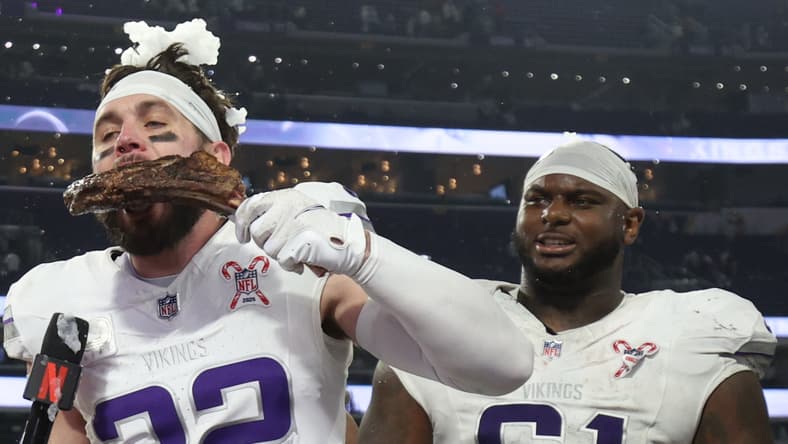 Harrison Smith eats a steak while being interviewed by Dianna Russini on the field at U.S. Bank Stadium after a Vikings game.