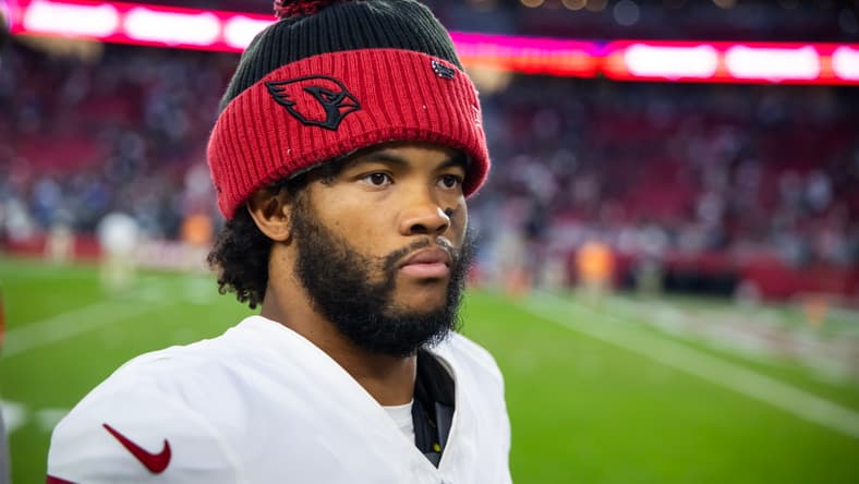 Kyler Murray stands on the field during a Cardinals game against the Patriots at State Farm Stadium. Vikings quarterback battle