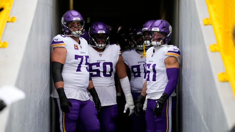 Brian O’Neill and Vikings teammates await kickoff before a game at Lambeau Field.