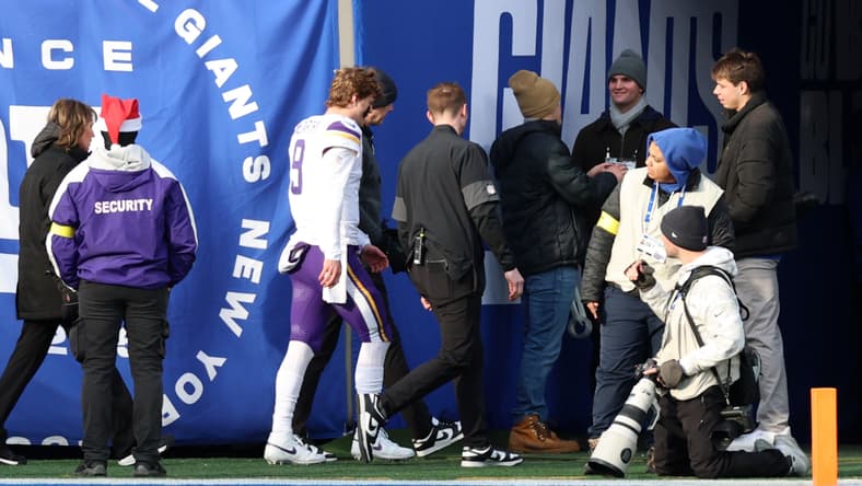 J.J. McCarthy leaves the field after an injury during a game against the New York Giants.
