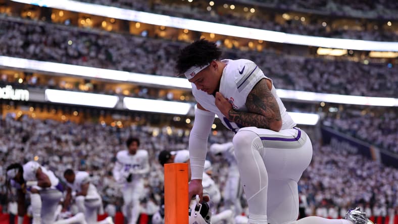 Ivan Pace Jr. kneels in the end zone before a Vikings game at U.S. Bank Stadium