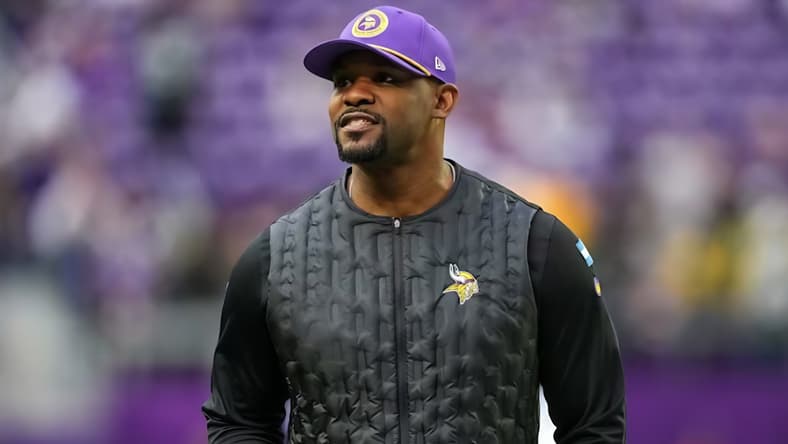 Brian Flores looks over the field before a Vikings game against the Packers at U.S. Bank Stadium.