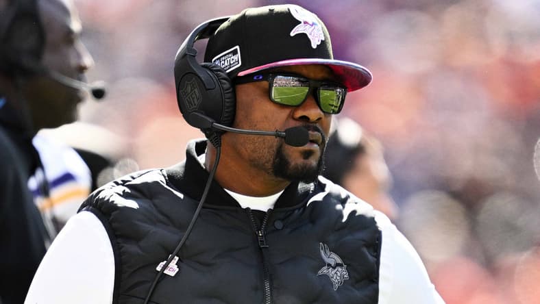 Brian Flores watching from sideline during Vikings vs Bears game at Soldier Field