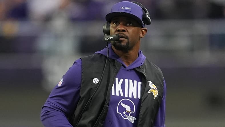 Brian Flores watches the field during a Vikings game against the Green Bay Packers at U.S. Bank Stadium. Vikings 2026 prediction
