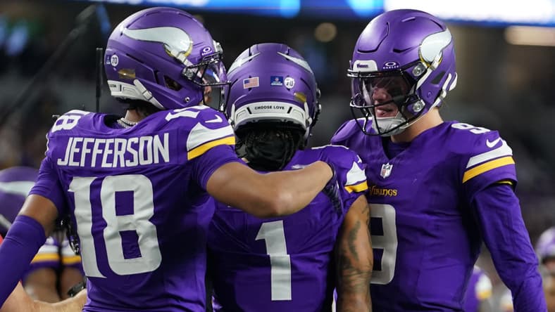 Jalen Nailor celebrates a touchdown with Justin Jefferson and J.J. McCarthy during a game against the Cowboys.