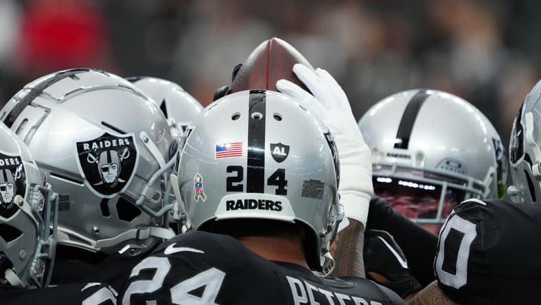 A Las Vegas Raiders huddle in 2023.