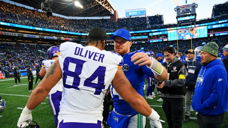 Seahawks QB Sam Darnold and TE Josh Oliver embrace in 2025