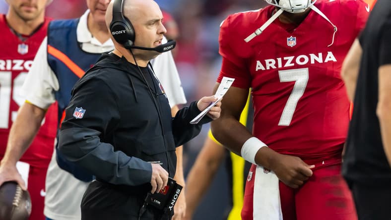 Drew Petzing and Jacoby Brissett stand on the sideline during a Cardinals game.