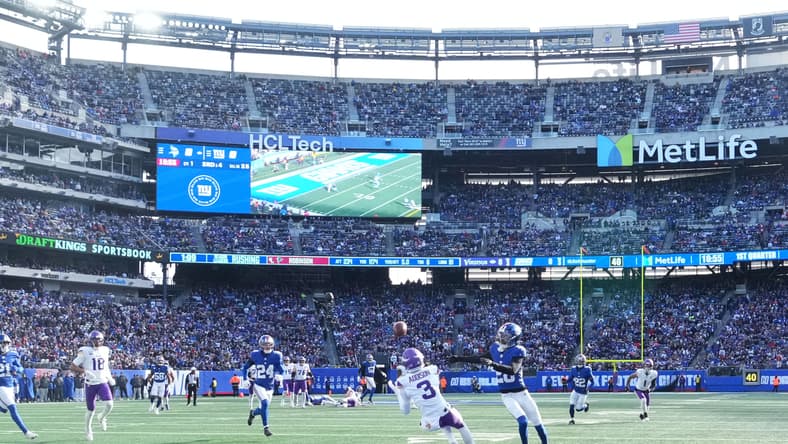 Vikings wide receiver Jordan Addison attempts to catch a pass against Giants cornerback Cordale Flott.