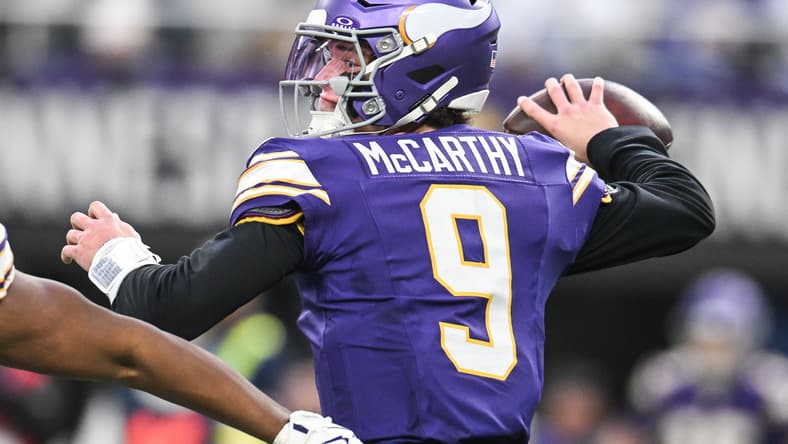 J.J. McCarthy throws a pass against the Packers at U.S. Bank Stadium.