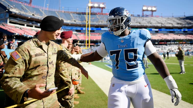 Lloyd Cushenberry III greets a military member before a game at Nissan Stadium.