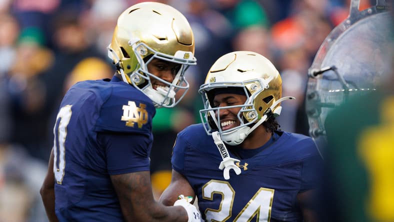 Jadarian Price and Malachi Fields celebrate a touchdown at Notre Dame Stadium.