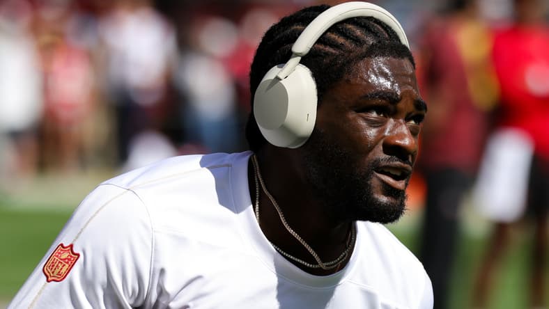 Brandon Aiyuk warms up before a game between the San Francisco 49ers and New England Patriots. NFL predictions