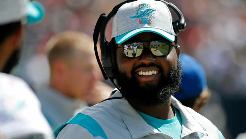 Dolphins defensive backs coach Gerald Alexander smiles on the sideline during a preseason game against the Bears.