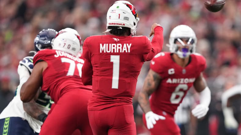 Kyler Murray throwing a pass to James Conner during a Cardinals game against the Seahawks