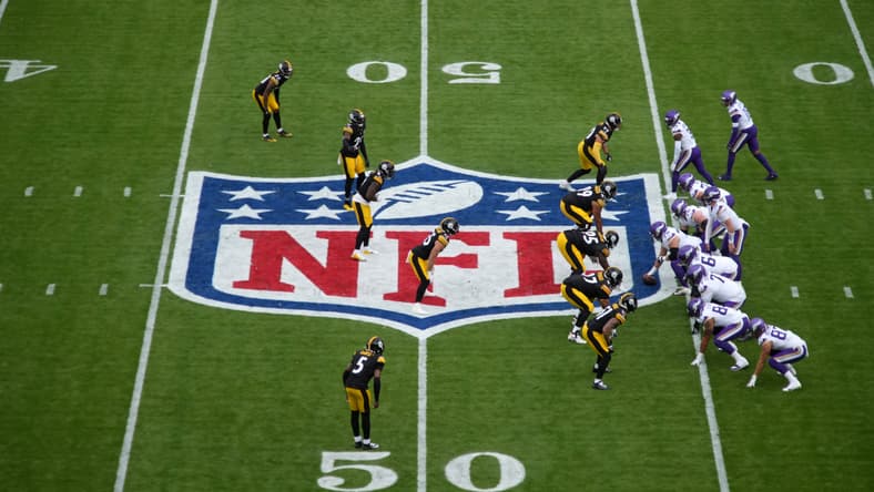 Carson Wentz taking a snap at midfield during a Vikings vs Steelers game in Dublin