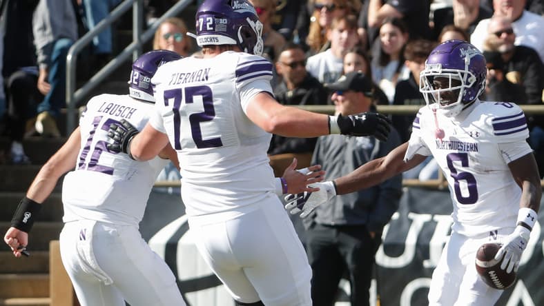 Caleb Tiernan celebrates a touchdown with teammates during a Northwestern game. Vikings rookies