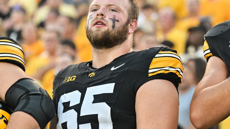 Logan Jones looks on during pregame warmups at Kinnick Stadium. Vikings center draft