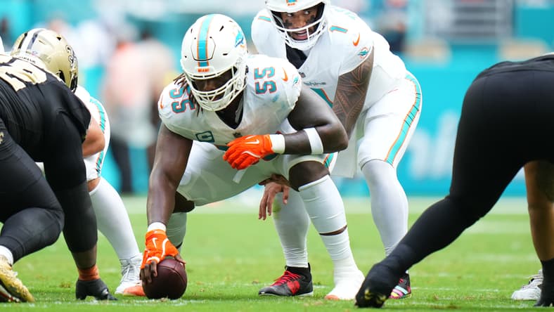 Tua Tagovailoa takes a snap behind center Aaron Brewer during a Dolphins game. Vikings cap space