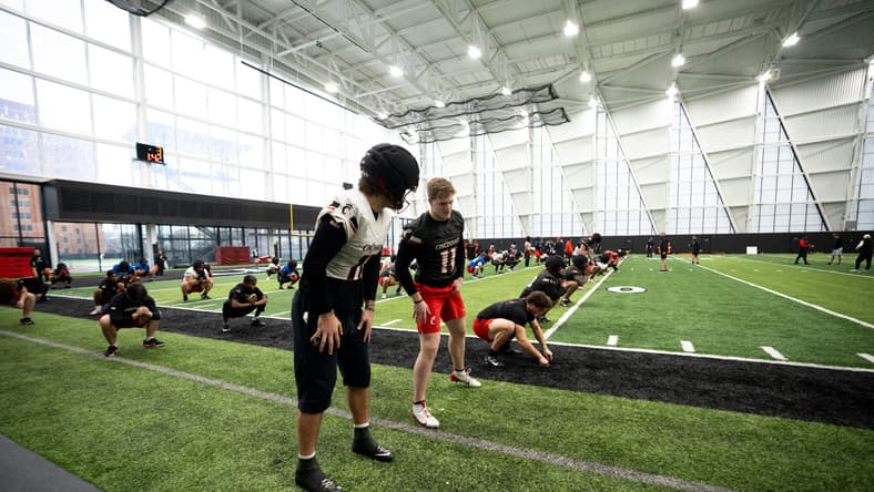 Cincinnati players Joe Royer and Jake Golday talk during football practice at Sheakley Athletic Performance Center.