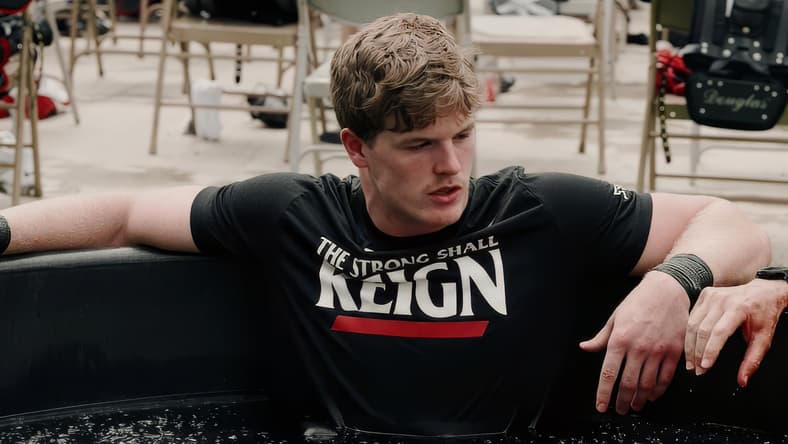 Jake Golday sits in a cold tub during a Cincinnati football training and recovery session.