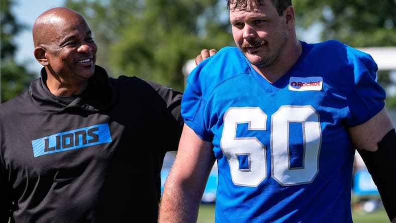 Lions assistant general manager Ray Agnew walks beside Graham Glasgow after training camp practice in Allen Park. Vikings GM candidates