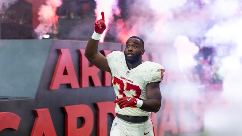 Trey Benson runs with the football during a Cardinals game against the Seattle Seahawks. Vikings trades