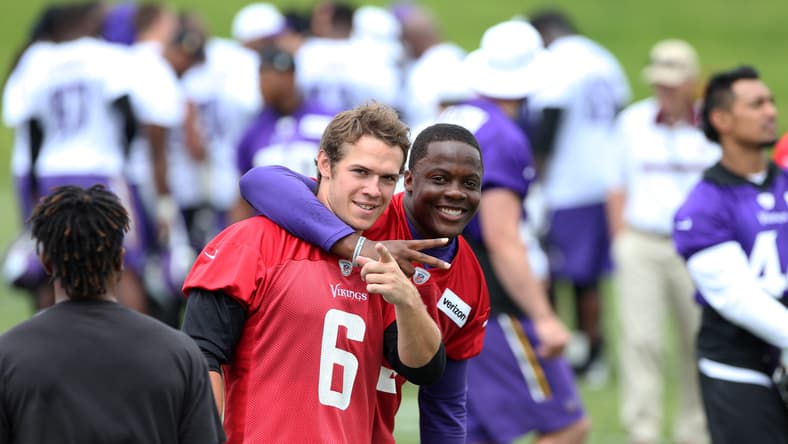 Teddy Bridgewater and Taylor Heinicke react after Minnesota Vikings minicamp practice in Minneapolis.