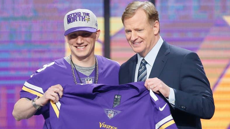 A fan poses with NFL commissioner Roger Goodell after being drafted by the Vikings in 2018.