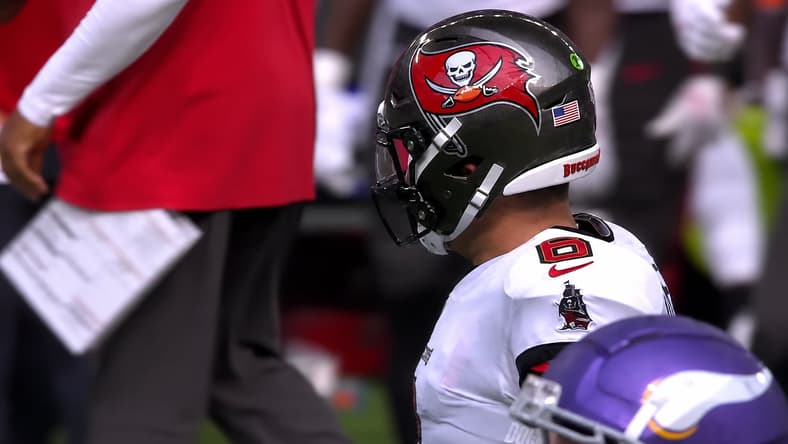Baker Mayfield in Tampa Bay uniform beside the Vikings sideline.
