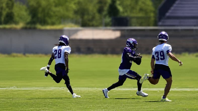 Kyler Murray throws a pass to Dillon Bell during Vikings minicamp practice in Eagan.
