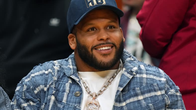 Aaron Donald reacts while attending a Los Angeles Sparks game at Crypto.com Arena.