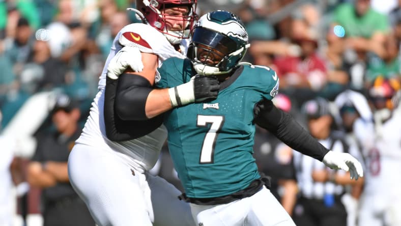 Haason Reddick is blocked by Andrew Wylie during Eagles-Commanders action.